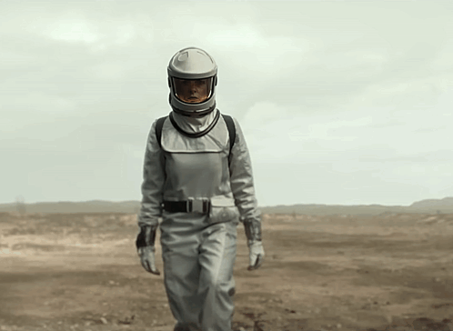 Woman in Space Suit Walking in Desert