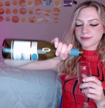 Woman in Spiderman Costume Pouring Wine