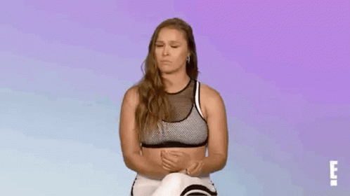 Woman in Sports Bra and Leggings Sitting with Eyes Closed