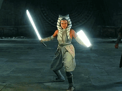 Woman in Star Wars Costume Holding Lightsaber