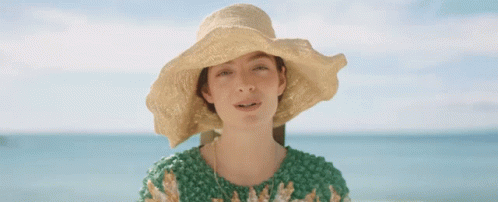 Woman in Straw Hat and Green Sweater Ocean