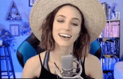 Woman in Straw Hat Talking Into Microphone