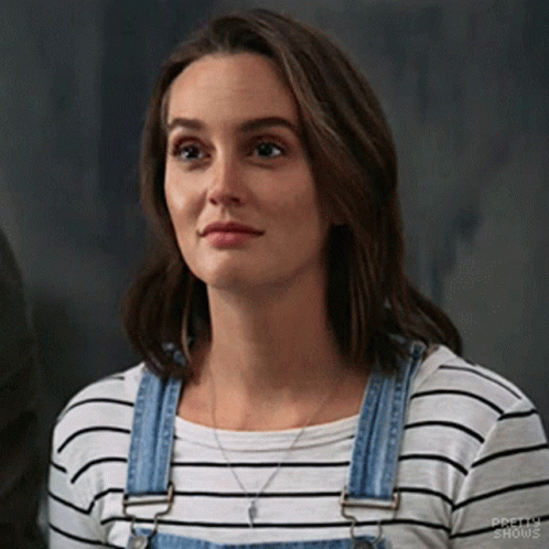 Woman in Striped Shirt and Overalls Looking