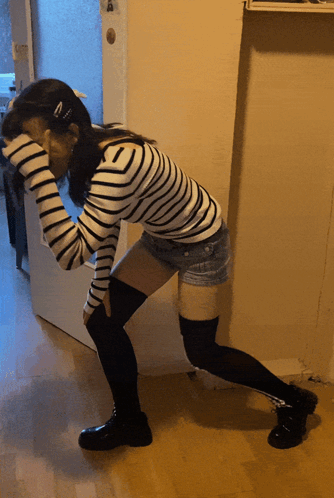 Woman In Striped Shirt And Shorts Kneeling GIF