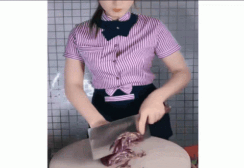 Woman in Striped Shirt Cutting Piece of Meat