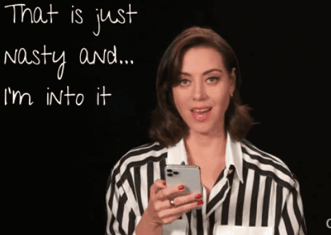Woman in Striped Shirt Looking at Phone