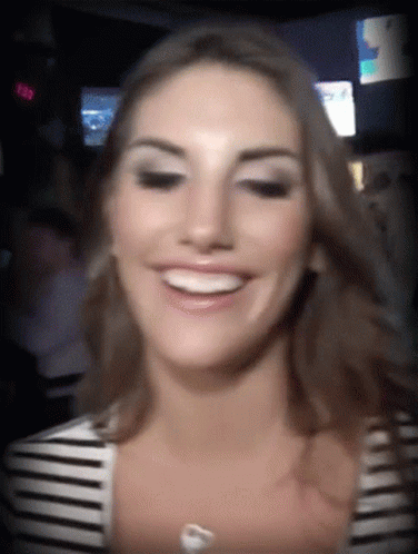 Woman in Striped Shirt Smiling at 8:08 Clock