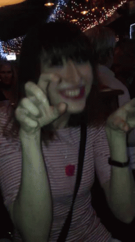 Woman In Striped Shirt Smiling With Hands Up GIF