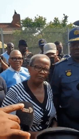Woman In Striped Shirt Speaking Into Microphone GIF