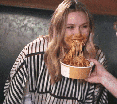 Woman in Striped Sweater Eating Spaghetti