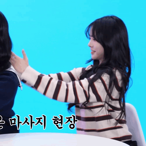 Woman in Striped Sweater Holding Another Woman's Hand