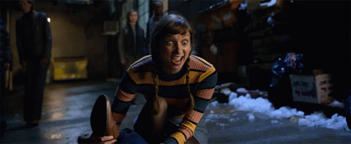 Woman In Striped Sweater Sitting With Mouth Open GIF