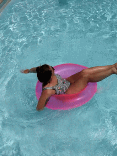 Woman in Striped Swimsuit on Pink Float