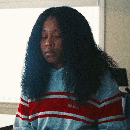 Woman In Striped Wilson Sweatshirt Looking Down GIF