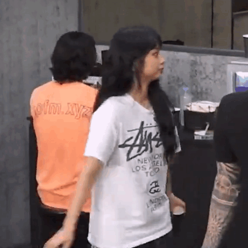 Woman in Stussy T-Shirt Standing in Front of Group
