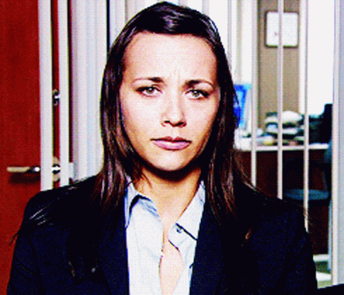 Woman in Suit and Blue Shirt Looking at Camera
