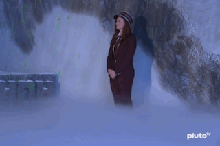 Woman in Suit and Hat in Cave