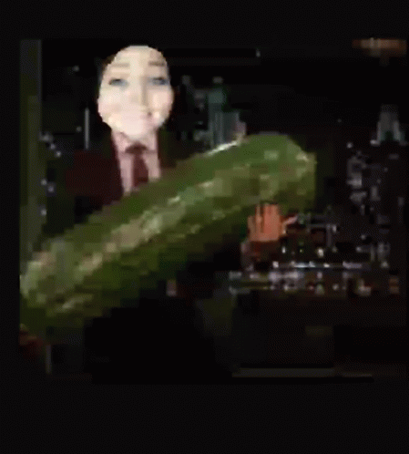 Woman In Suit And Tie Holding Large Cucumber GIF
