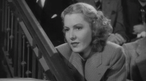 Woman in Suit and Tie on Staircase