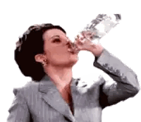 Woman in Suit Drinking Water