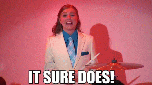 Woman in Suit Holding Drumstick It Sure Does