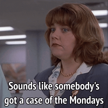 Woman in Suit Holding Paper Says Case of Mondays