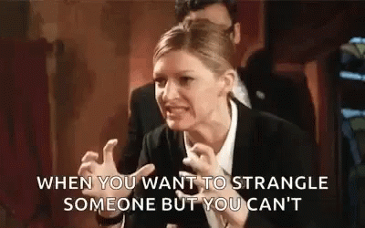 Woman In Suit Making Funny Face GIF