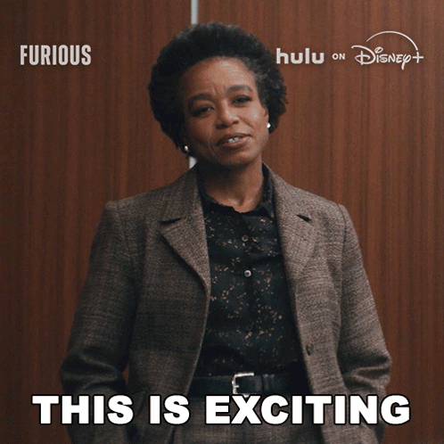 Woman In Suit Says This Is Exciting In Front Of Disney Logo GIF