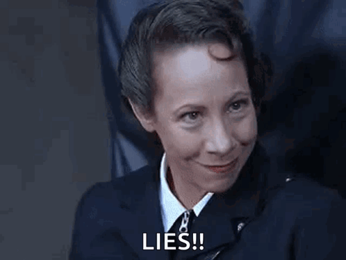 Woman in Suit Smiling Says Lies