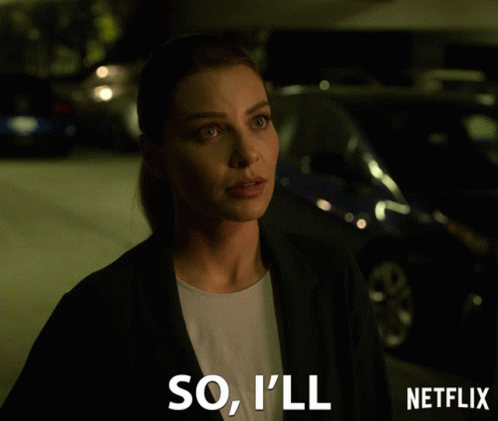 Woman In Suit Standing Before Netflix Sign GIF