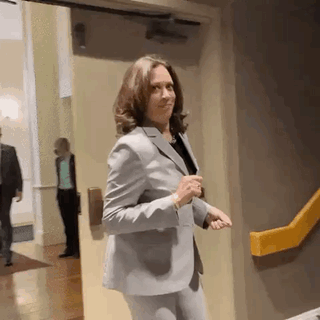 Woman in Suit Standing by Yellow Railing
