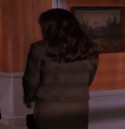 Woman in Suit Standing in Front of Painting