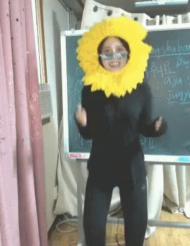 Woman in Sunflower Costume by Chinese Blackboard