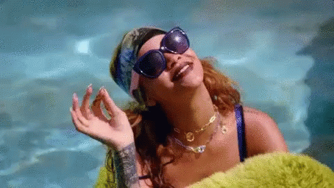 Woman in Sunglasses and Bandana Laying in Pool
