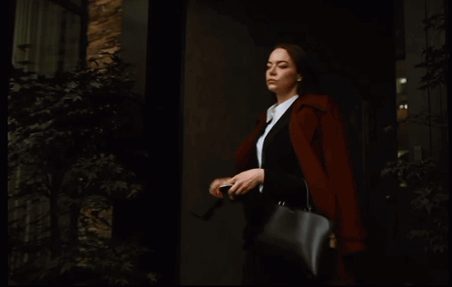 Woman in Sunglasses and Black Purse Looking at Phone