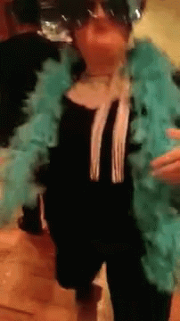 Woman In Sunglasses And Blue Boa Dancing GIF