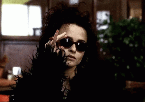 Woman In Sunglasses And Fur Coat Making Peace Sign GIF