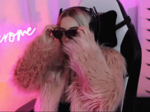 Woman in Sunglasses and Fur Coat Sitting