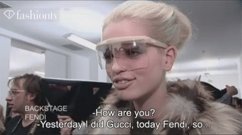 Woman in Sunglasses and Fur Coat Talking Gucci