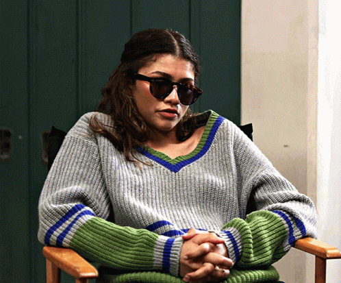 Woman in Sunglasses and Grey Green Sweater Sitting
