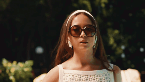 Woman in Sunglasses and Headband Looking to Side