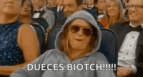 Woman in Sunglasses and Hoodie in Crowd