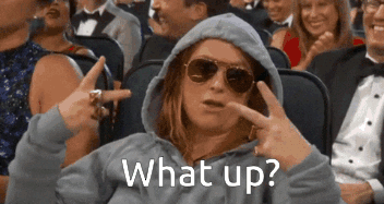 Woman in Sunglasses and Hoodie Saying What Up in Crowd