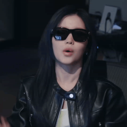 Woman in Sunglasses and Leather Jacket Making Funny Face