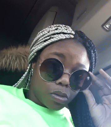 Woman in Sunglasses and Neon Green Shirt Giving Middle Finger