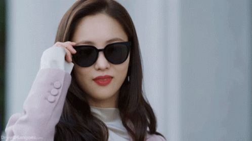 Woman In Sunglasses And Pink Jacket Drfreemangook.com GIF