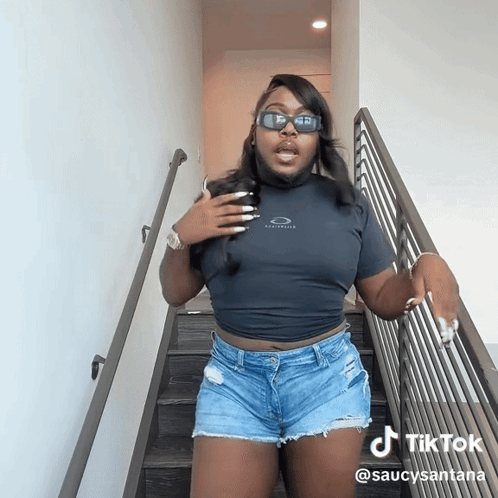 Woman in Sunglasses and Shorts on Stairs TikTok