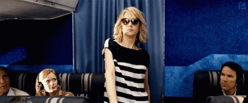 Woman in Sunglasses and Striped Shirt on Plane