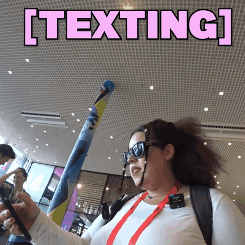 Woman in Sunglasses Holding Bat With Texting Above