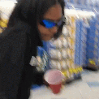 Woman in Sunglasses Holding Cup
